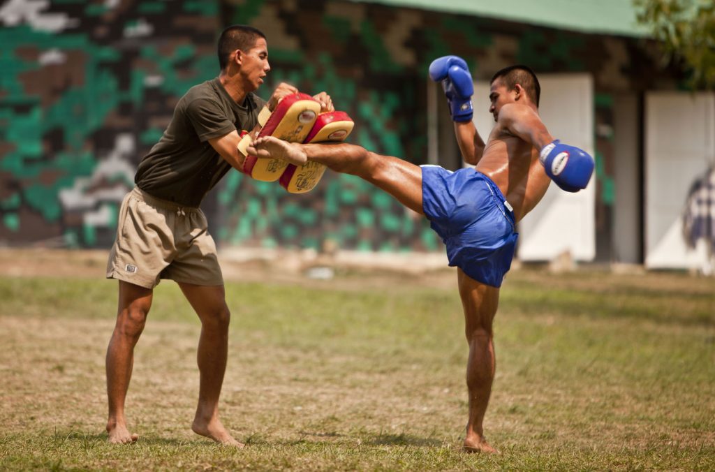 BAN CHAN KREM, Thailand -- During a cultural exchange, a Royal Thai Marine demonstrates his kicking ability which he utilizes for Thai boxing at the Ban Chan Krem training area here Feb. 15. Royal Thai Marines, Republic of Korea Marines and U.S. Marines with Combat Assault Battalion, 3rd Marine Division, III Marine Expeditionary Force, conducted trilateral training during Cobra Gold '12. Cobra Gold is a recurring multinational and multiservice exercise hosted by the Royal Kingdom of Thailand designed to advance regional security by exercising a multinational force from nations sharing common goals and security commitments in the Asia-Pacific region. (U.S. Marine Corps photo by Sgt. Brandon L. Saunders/released)